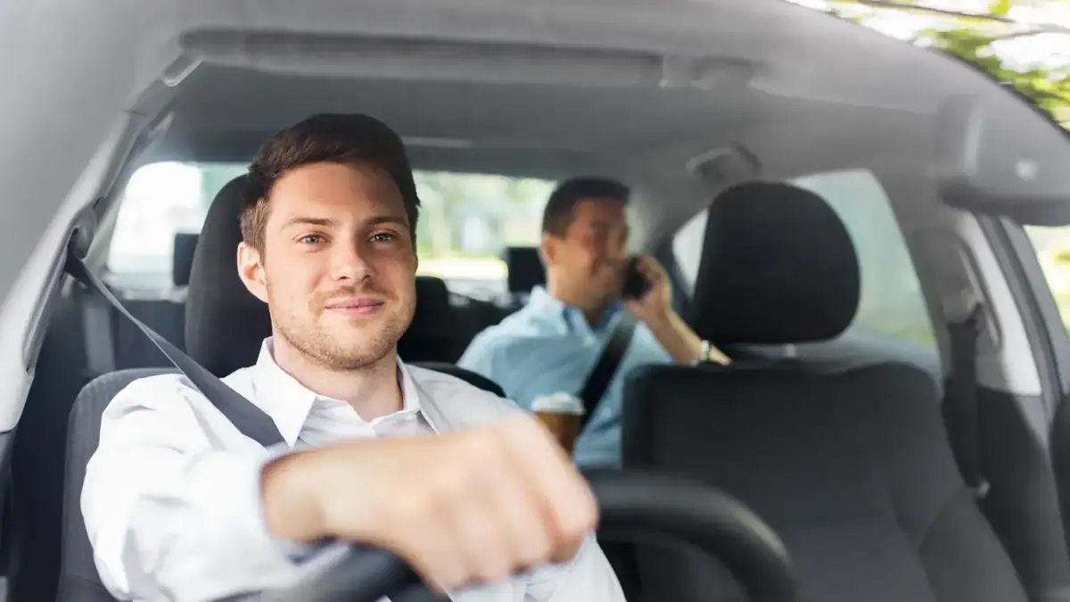 Professional taxi driver with passenger during a journey